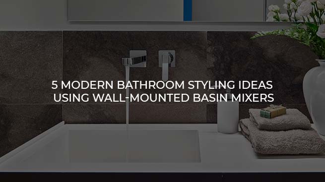 Close-up of a modern chrome wall-mounted basin mixer tap running water into a sleek white bathroom sink.